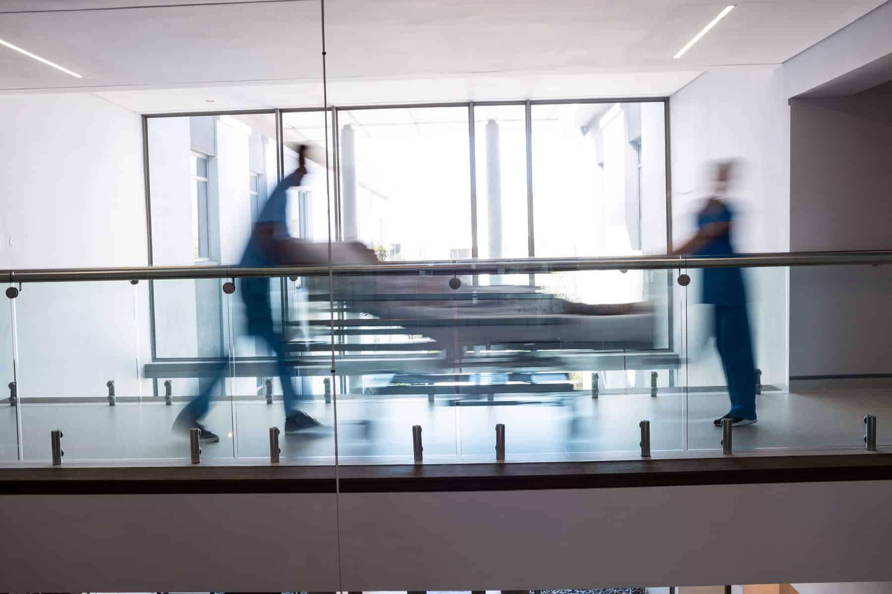 Team of doctors taking pregnant woman to operation theatre in the hospital