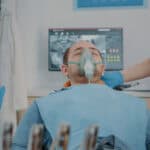 Patient with oxygen mask receiving anesthesic in dentistry